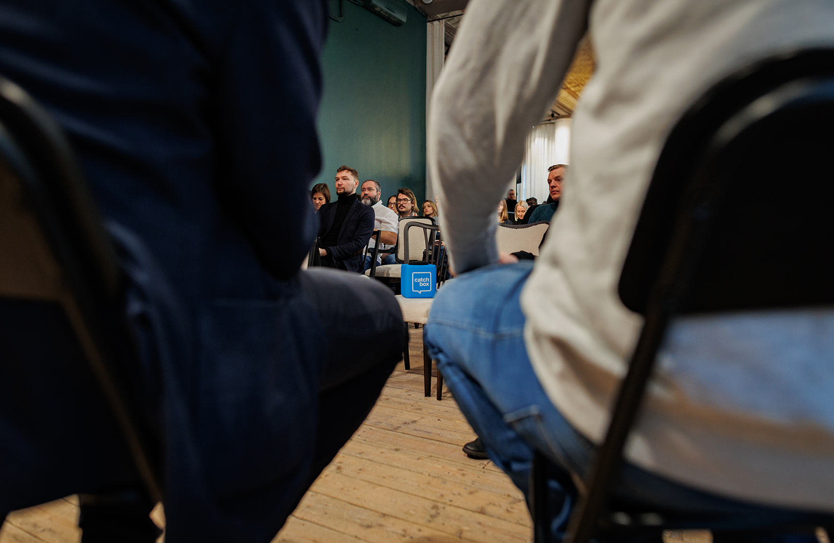 Participants engaged in a meeting, utilizing a Catchbox throwable microphone for dynamic and interactive discussions